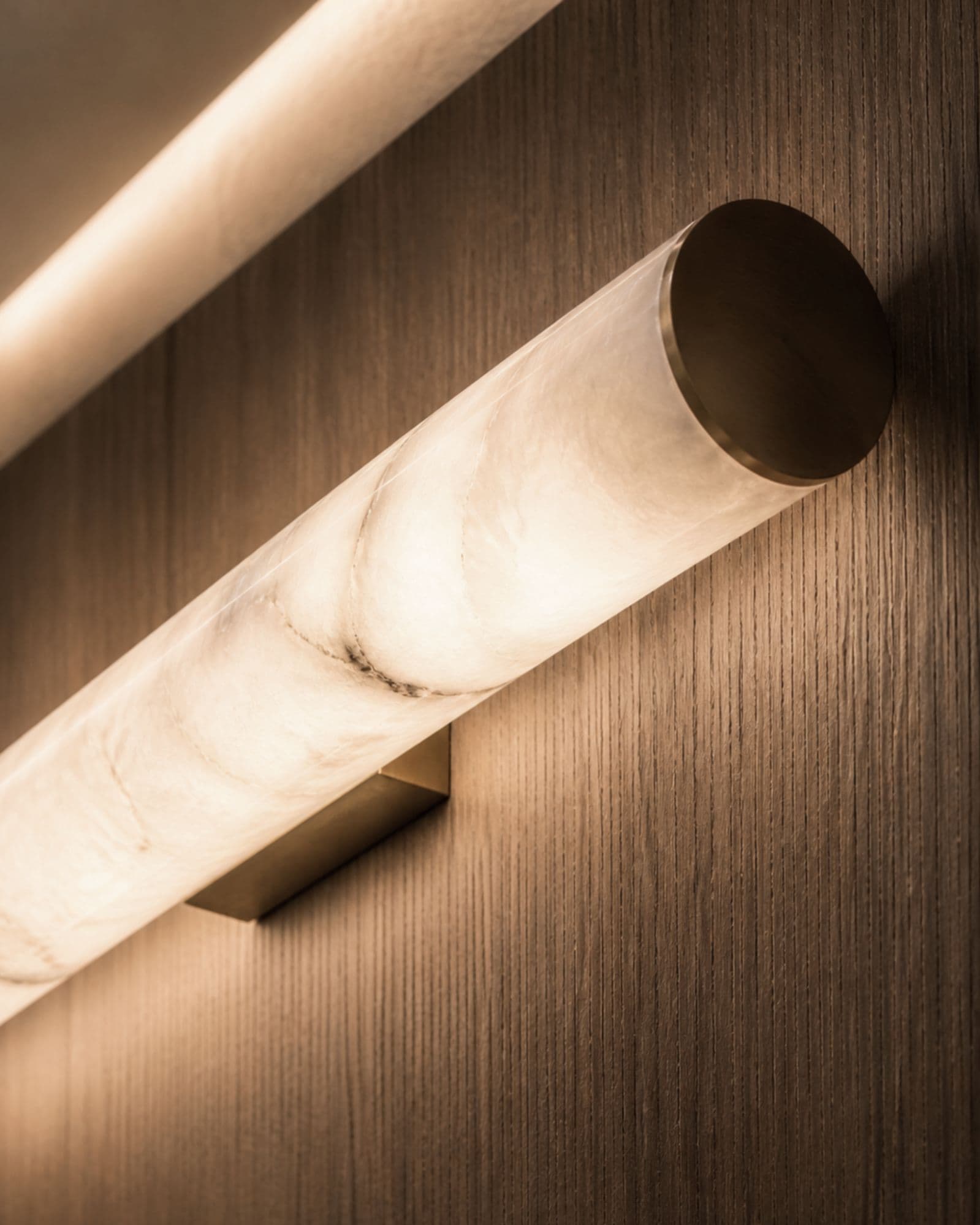 Hand-finished alabaster lighting on wood paneling